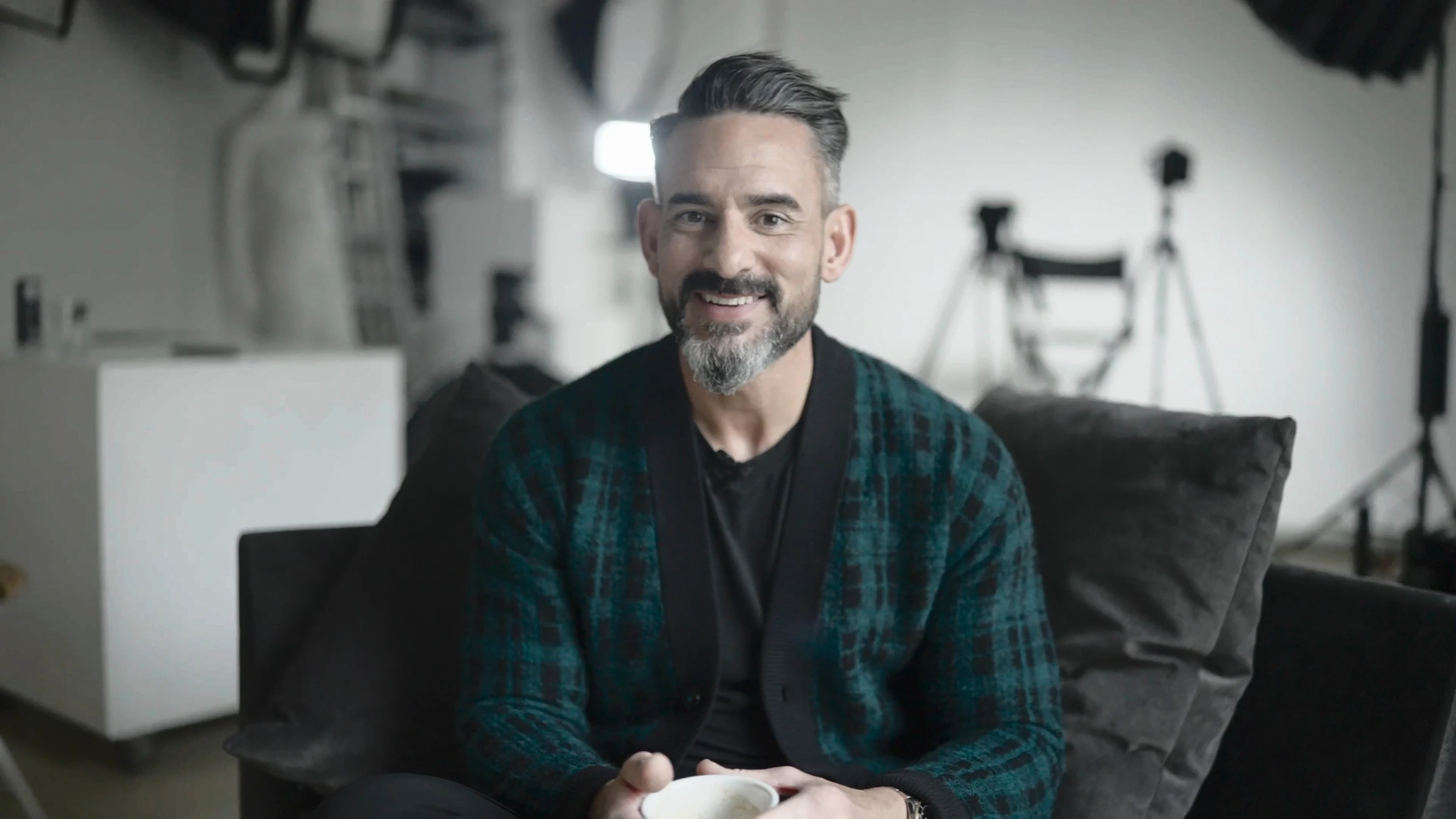 Nick Connor on a couch, smiling at the camera